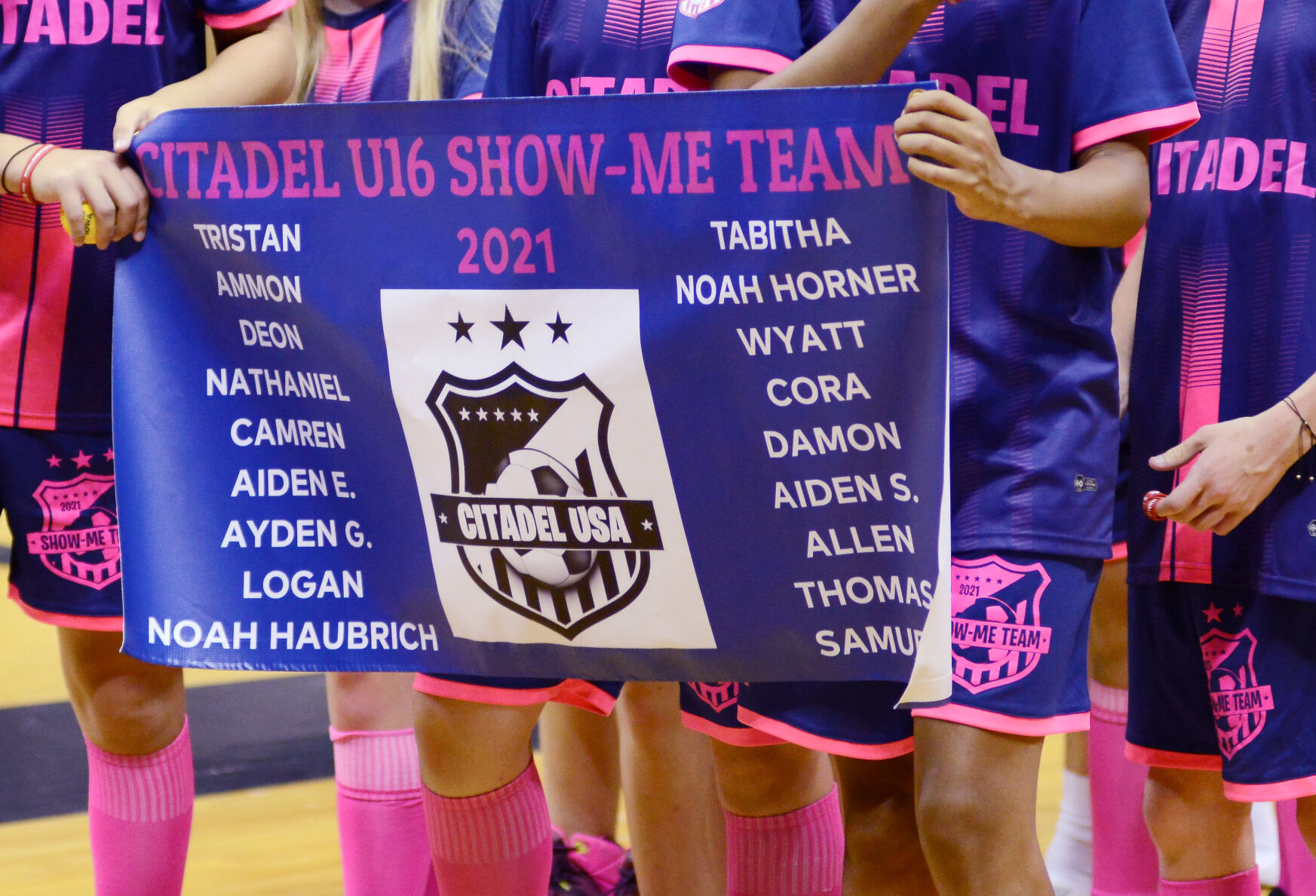 The Citadel U16 soccer team carries a banner